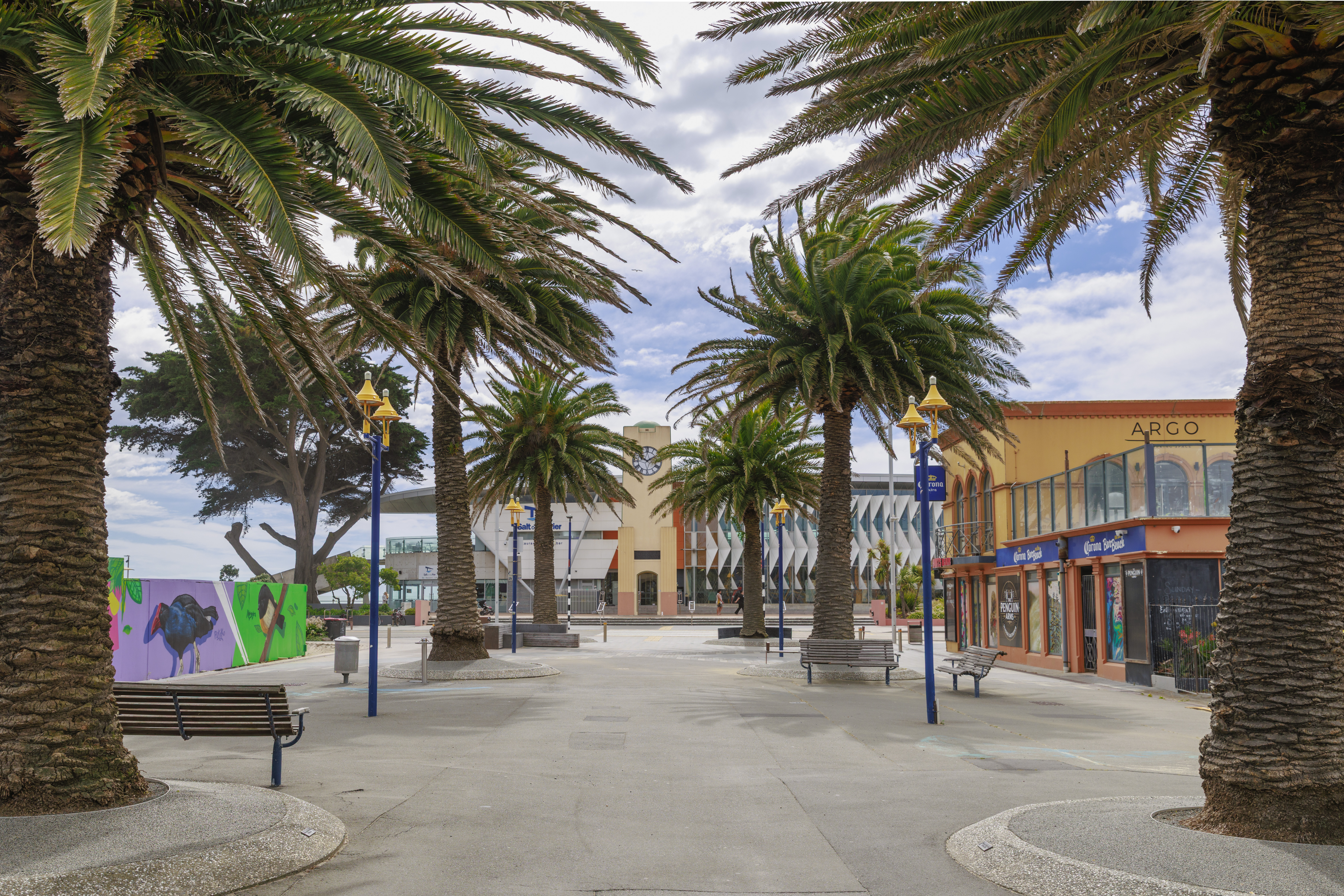 View of New Brighton Mall, featuring local shops, businesses, and the central pedestrian area that serves as a hub for the seaside community