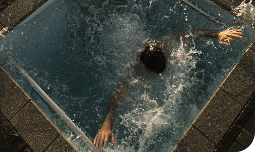 Man fully submerged in a plunge pool
