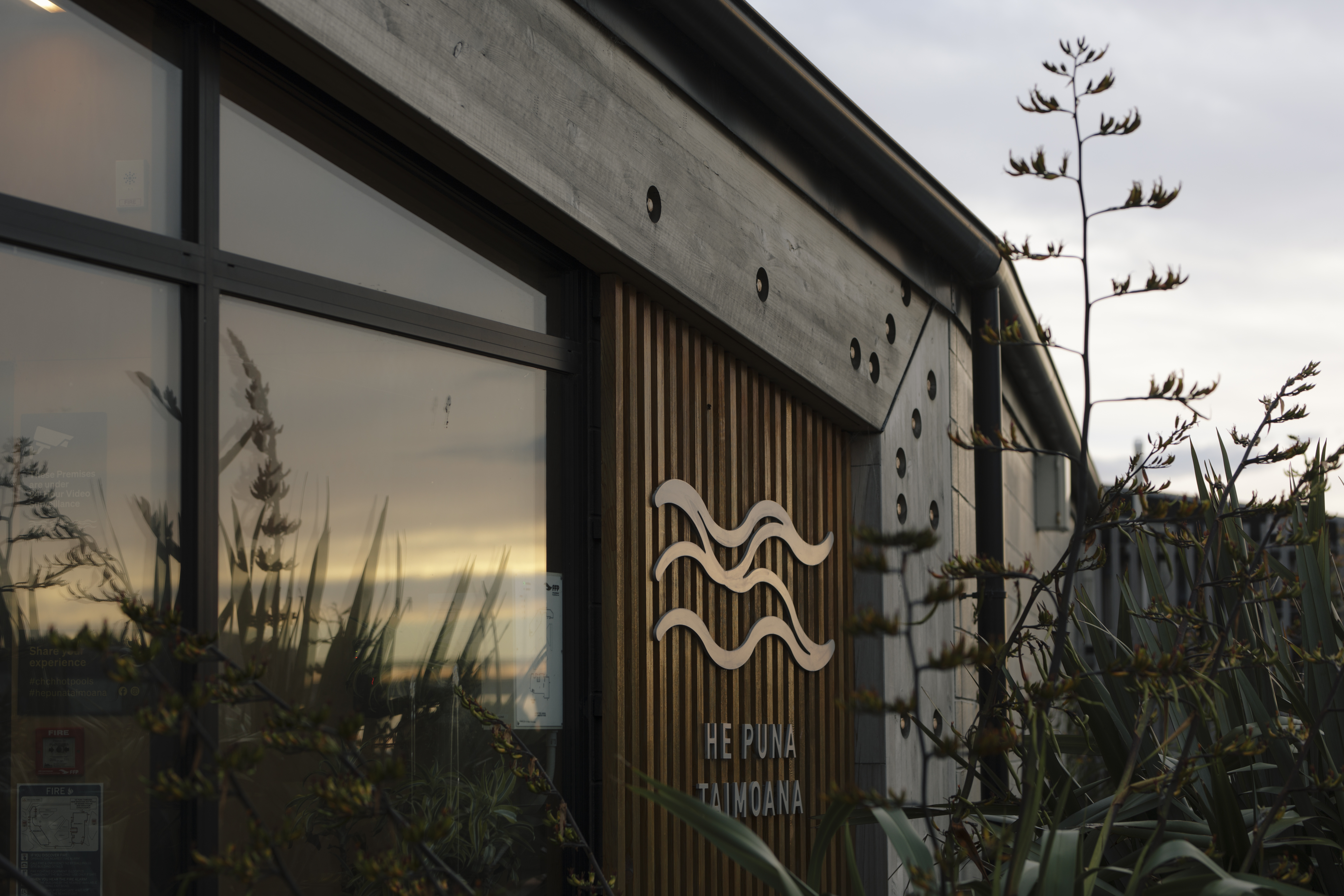 Close-up of the He Puna Taimoana building exterior, featuring the venue’s distinctive wave logo